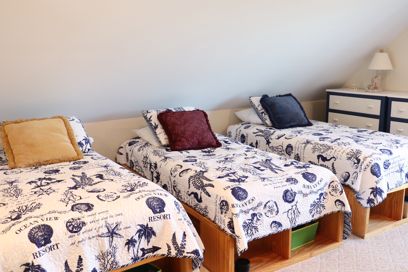 Drift off to sleep in your cozy twin bedroom, featuring ocean-themed linens and soft lighting that creates the perfect peaceful retreat.