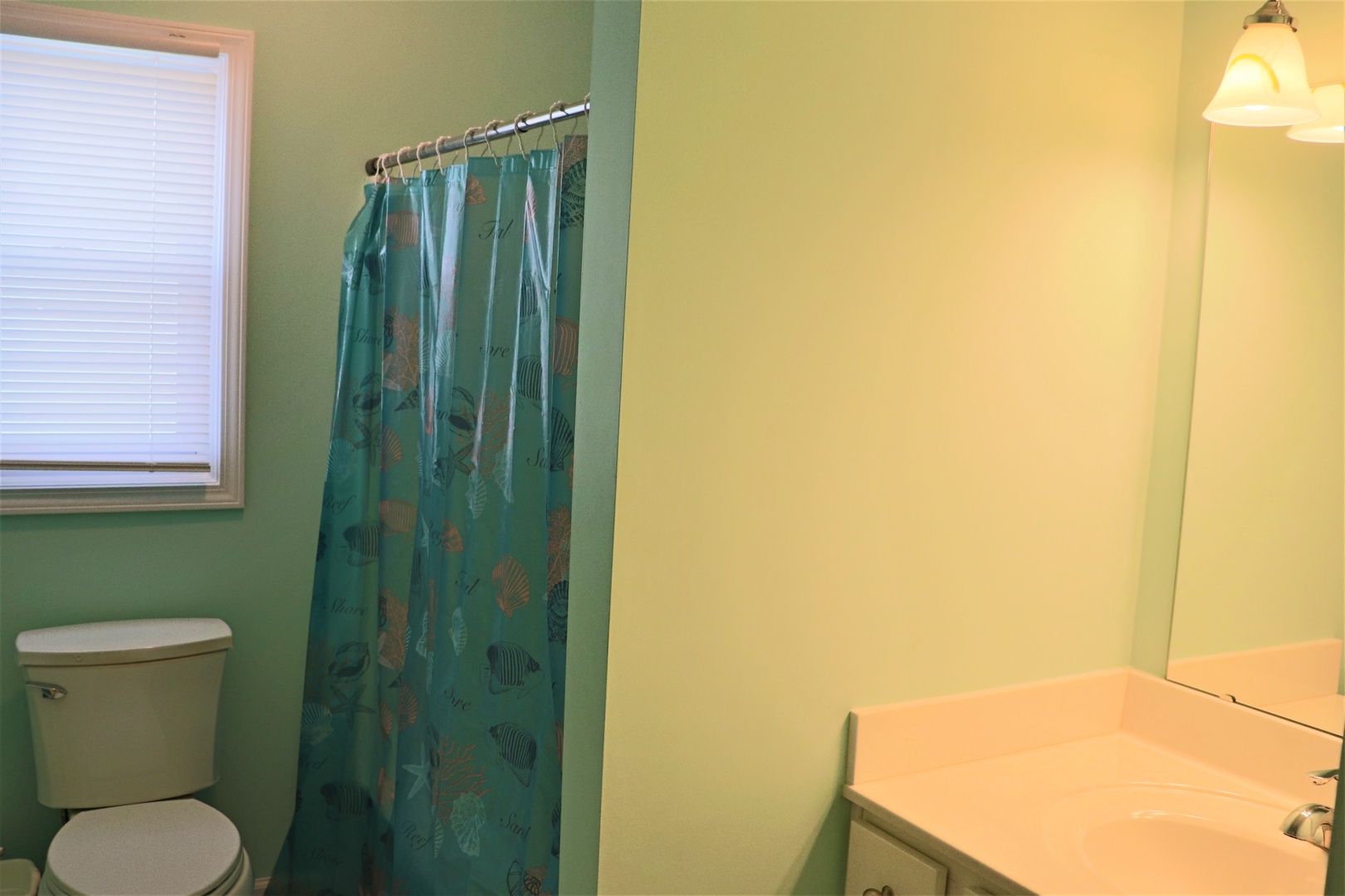 Refresh in your private bathroom with cheerful coastal vibes, featuring a relaxing shower and ocean-themed touches.