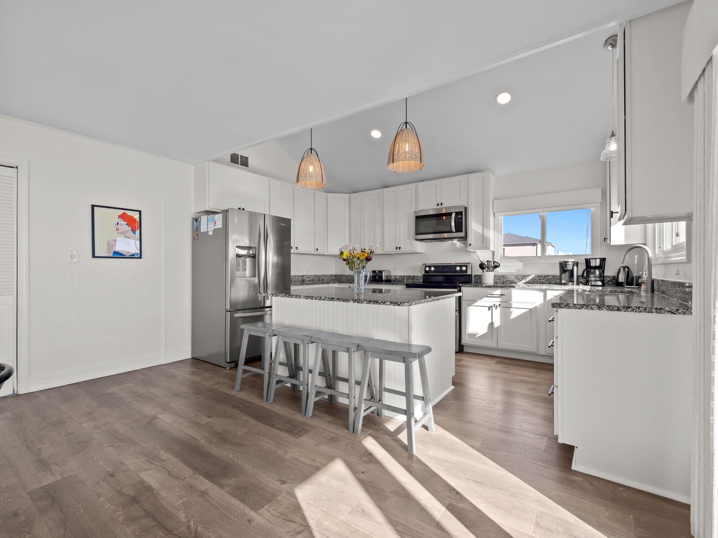 Your modern kitchen features granite counters, stainless steel appliances, and a breakfast bar perfect for morning coffee or evening conversations.