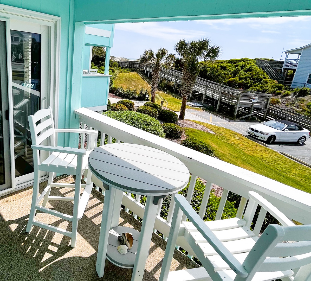 Sip your morning coffee on your private balcony while enjoying coastal views through swaying palms and manicured gardens.