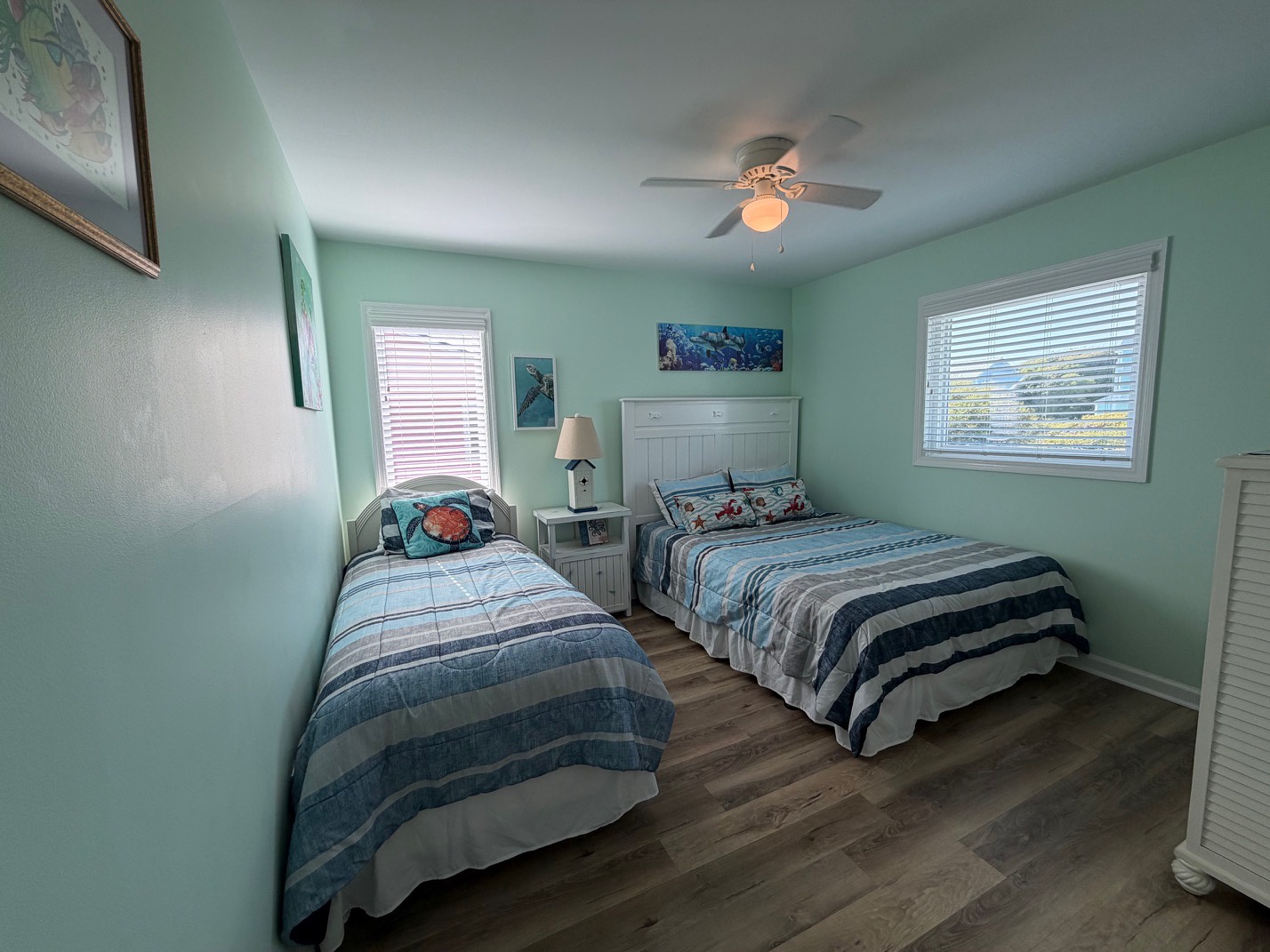 Your coastal-themed bedroom offers comfortable twin beds with cheerful blue linens, perfect for sharing stories after beach adventures.
