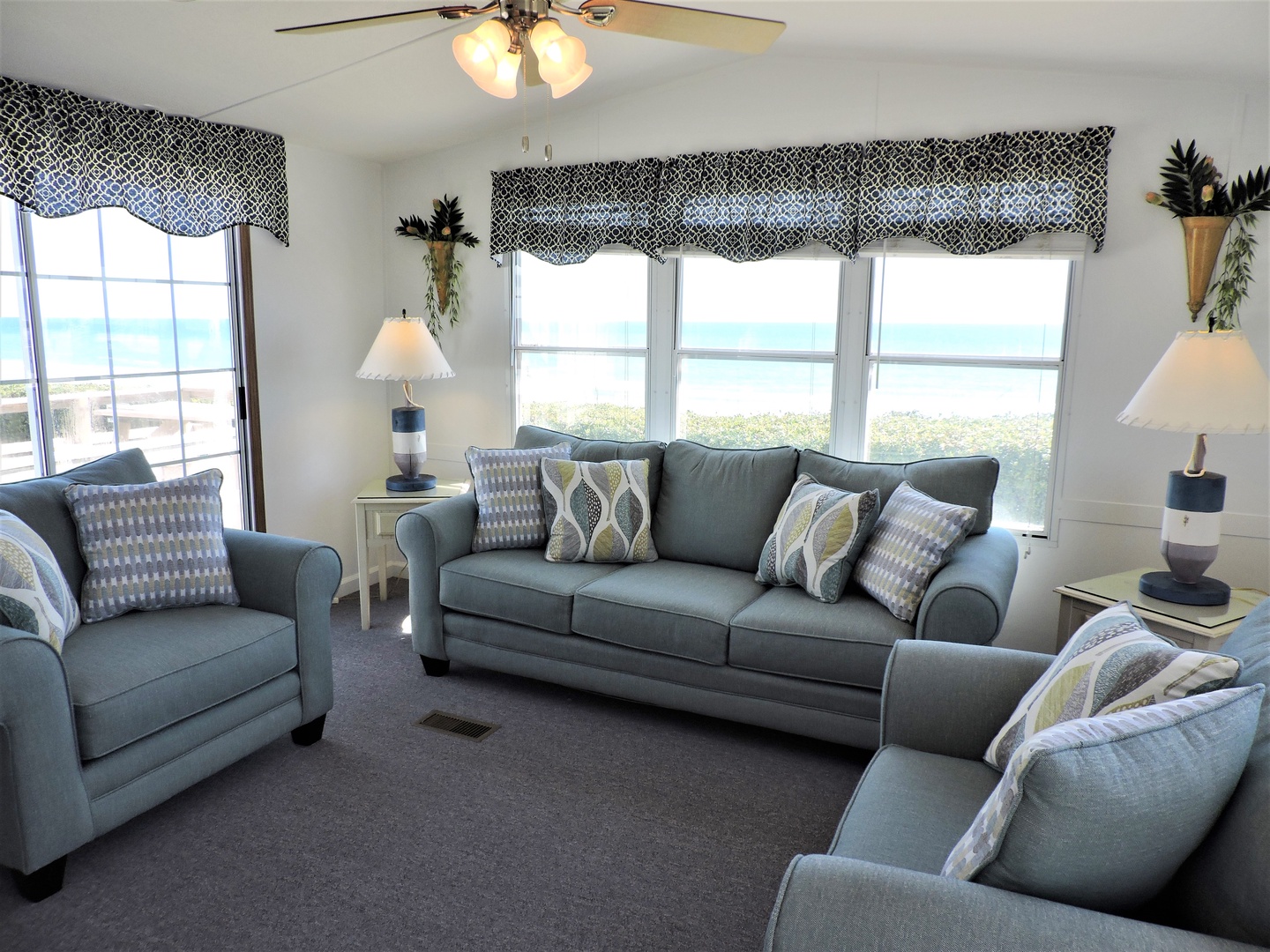 Sink into plush seating while ocean breezes flow through your windows and coastal charm surrounds you in this peaceful retreat.
