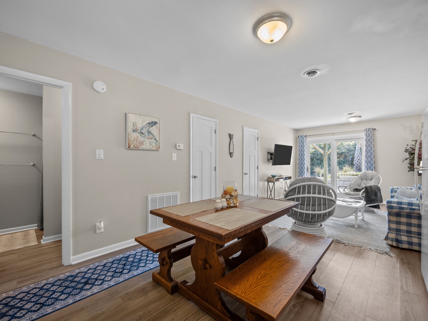 Gather around your rustic dining table where coastal charm meets comfort in this open living space with TV entertainment.