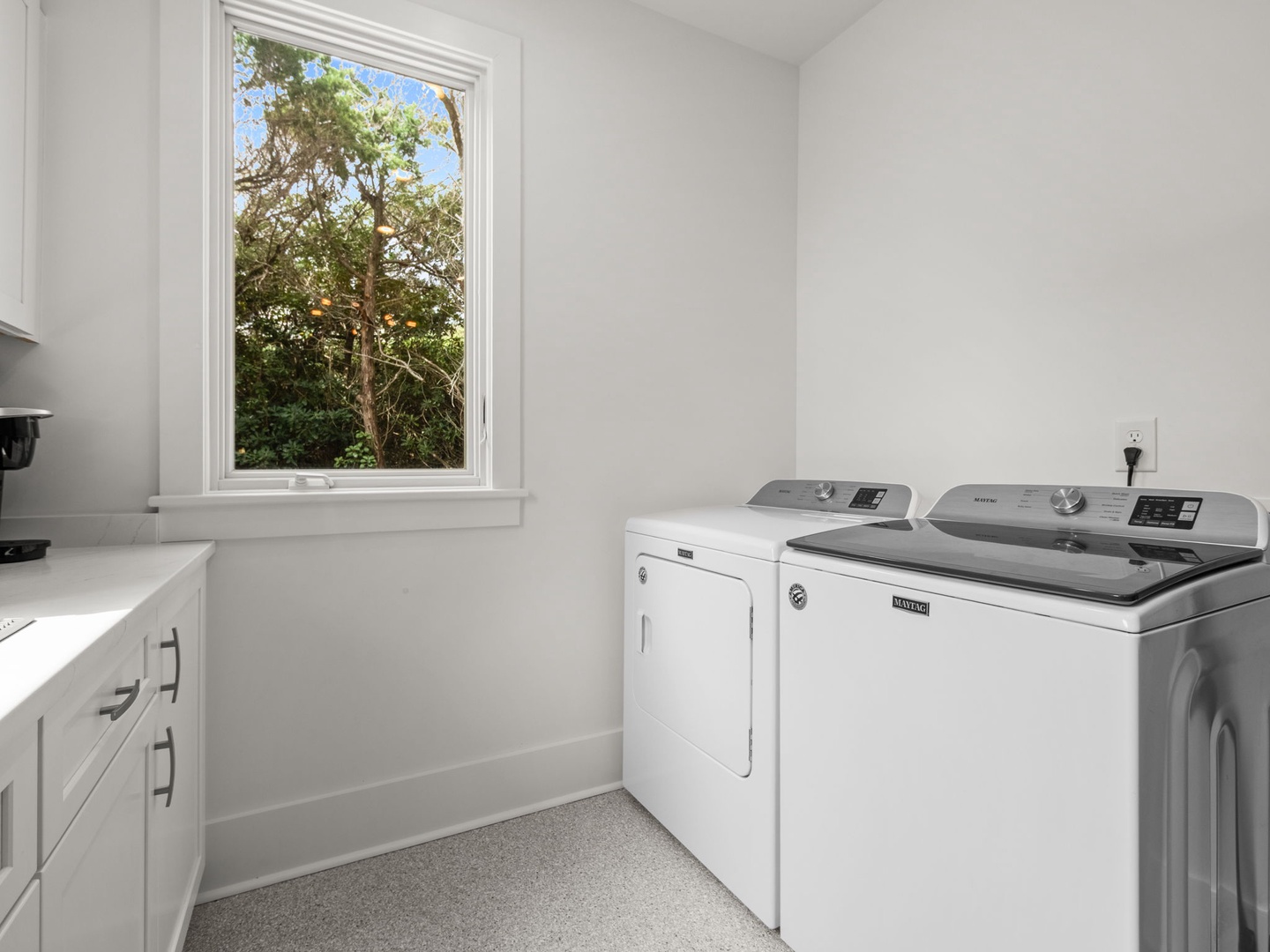 Your personal laundry room features full-sized washer and dryer with natural light streaming through the garden-view window.