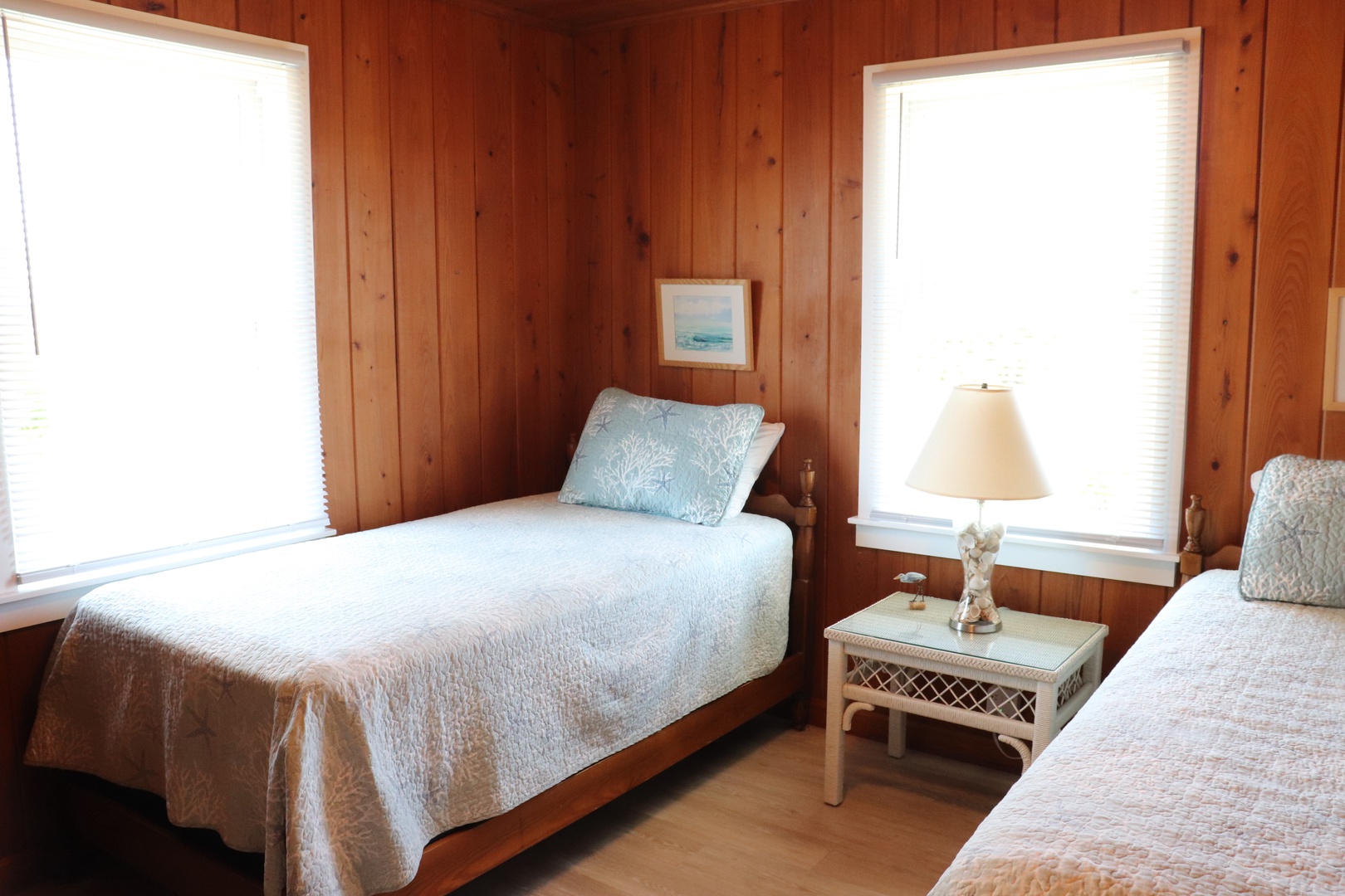 Rest peacefully in your cozy twin bedroom, where warm wood walls and soft linens create the perfect retreat.