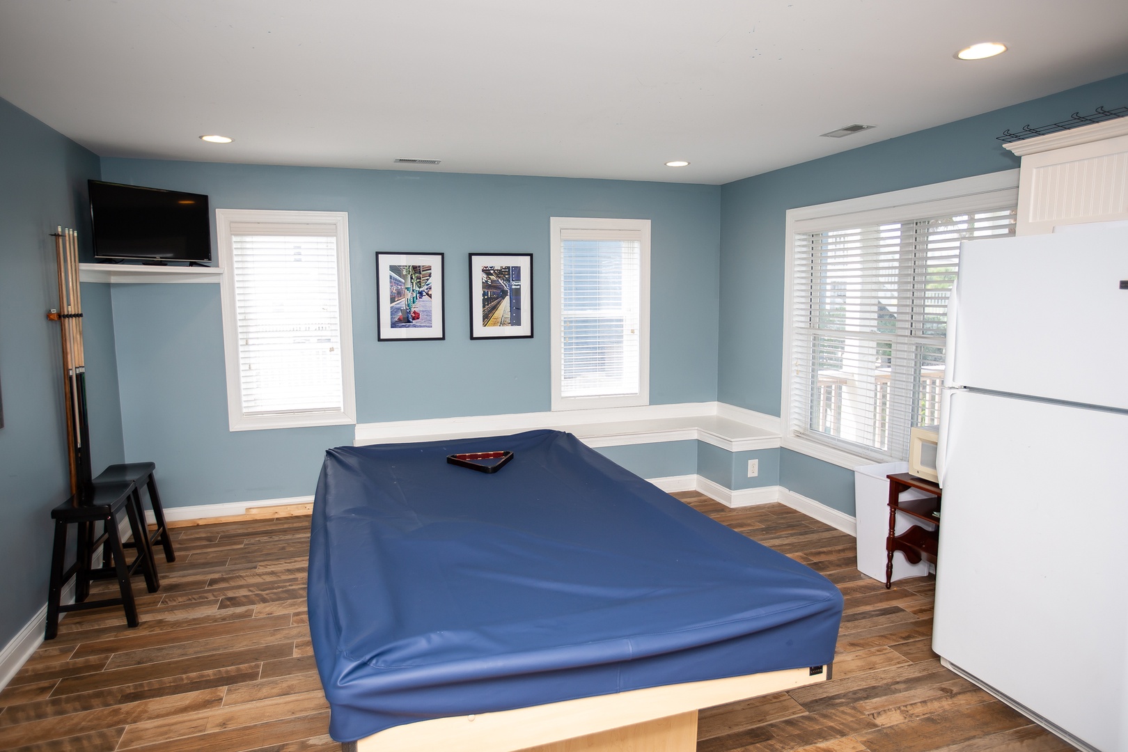 Your entertainment space features a pool table with built-in seating, perfect for game nights in comfort.