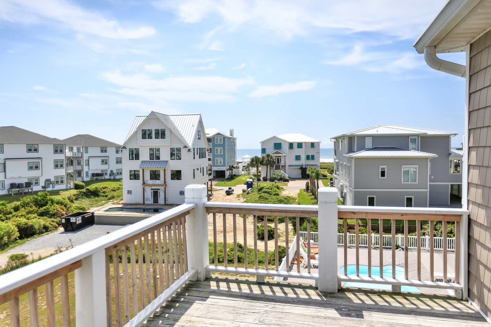 Step onto your private balcony and soak in stunning coastal views stretching to the ocean beyond neighboring beach homes.