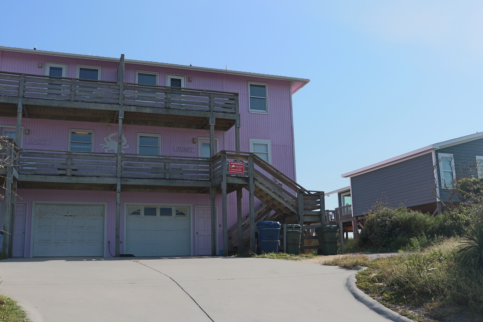 Colorful beach houses with spacious parking and coastal charm in a peaceful neighborhood setting.