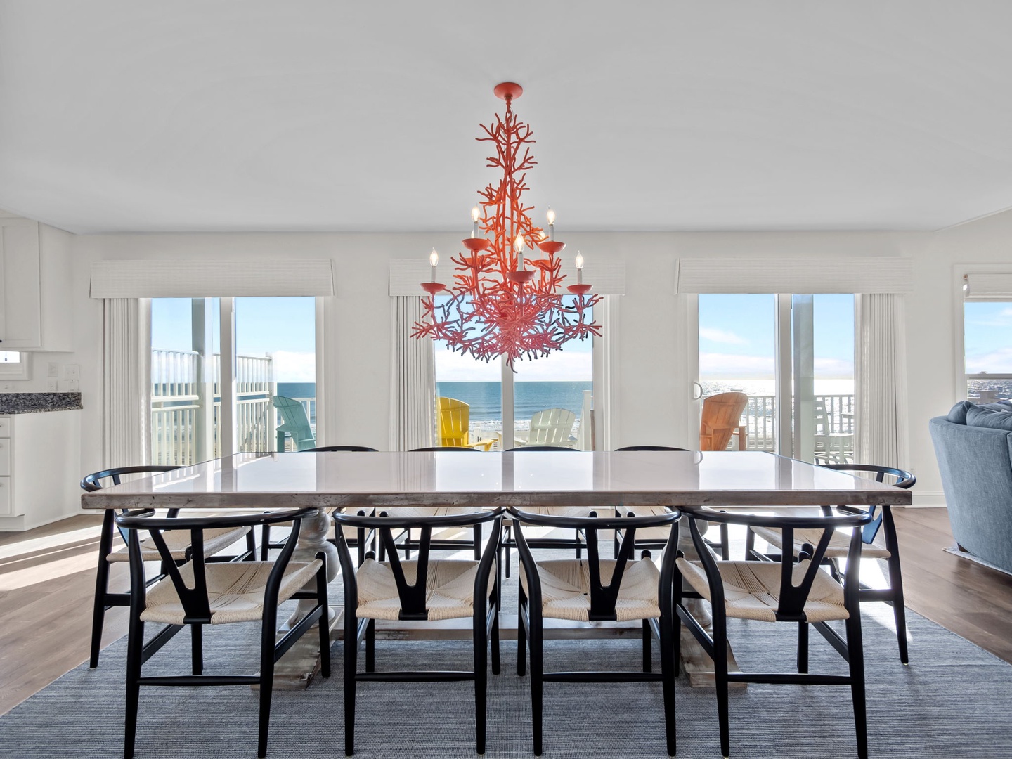 Your dining space opens to stunning oceanfront views with colorful deck seating just steps away through floor-to-ceiling windows.
