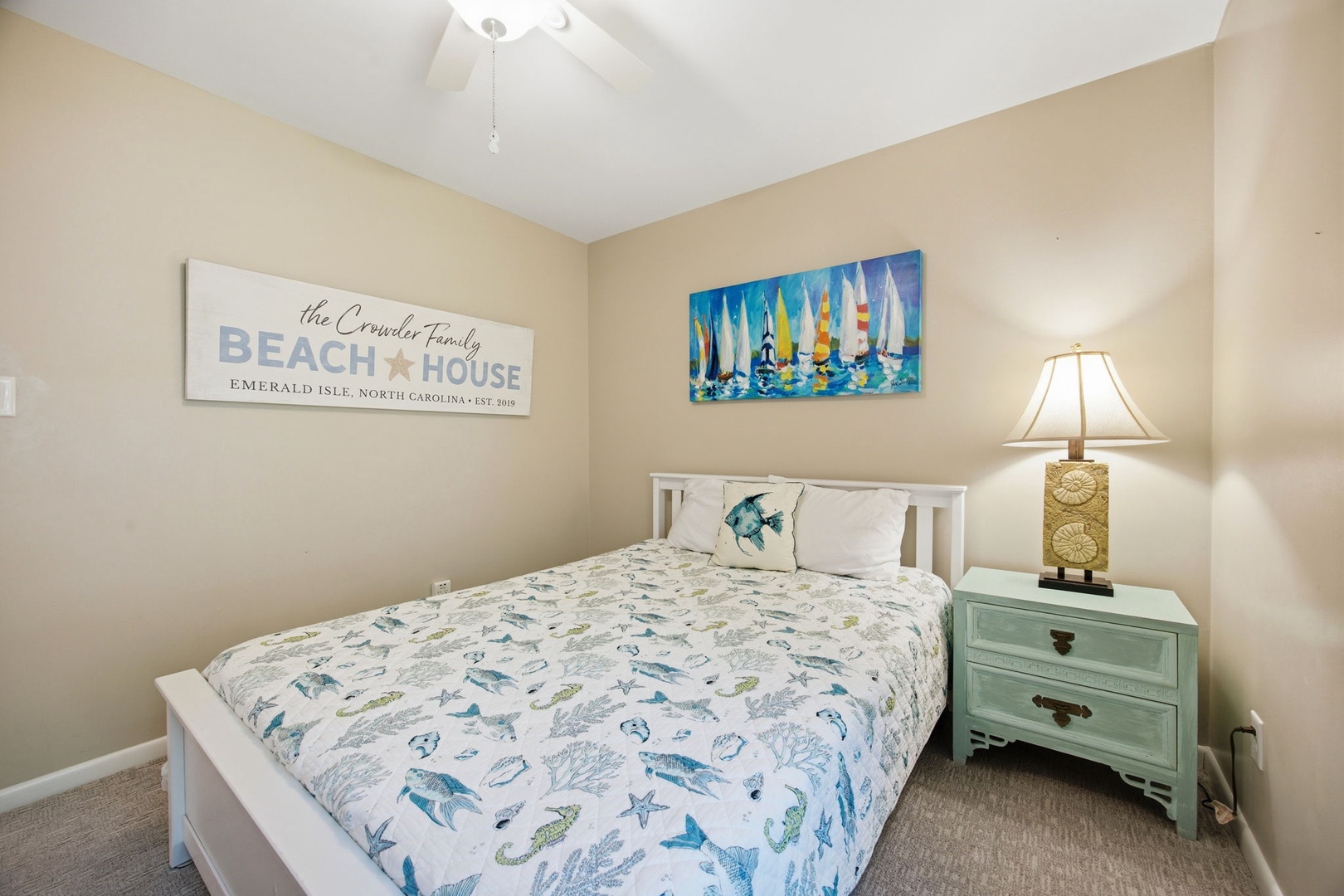 Drift off in your cozy beach-themed bedroom featuring ocean-inspired bedding and coastal artwork that brings seaside tranquility indoors.