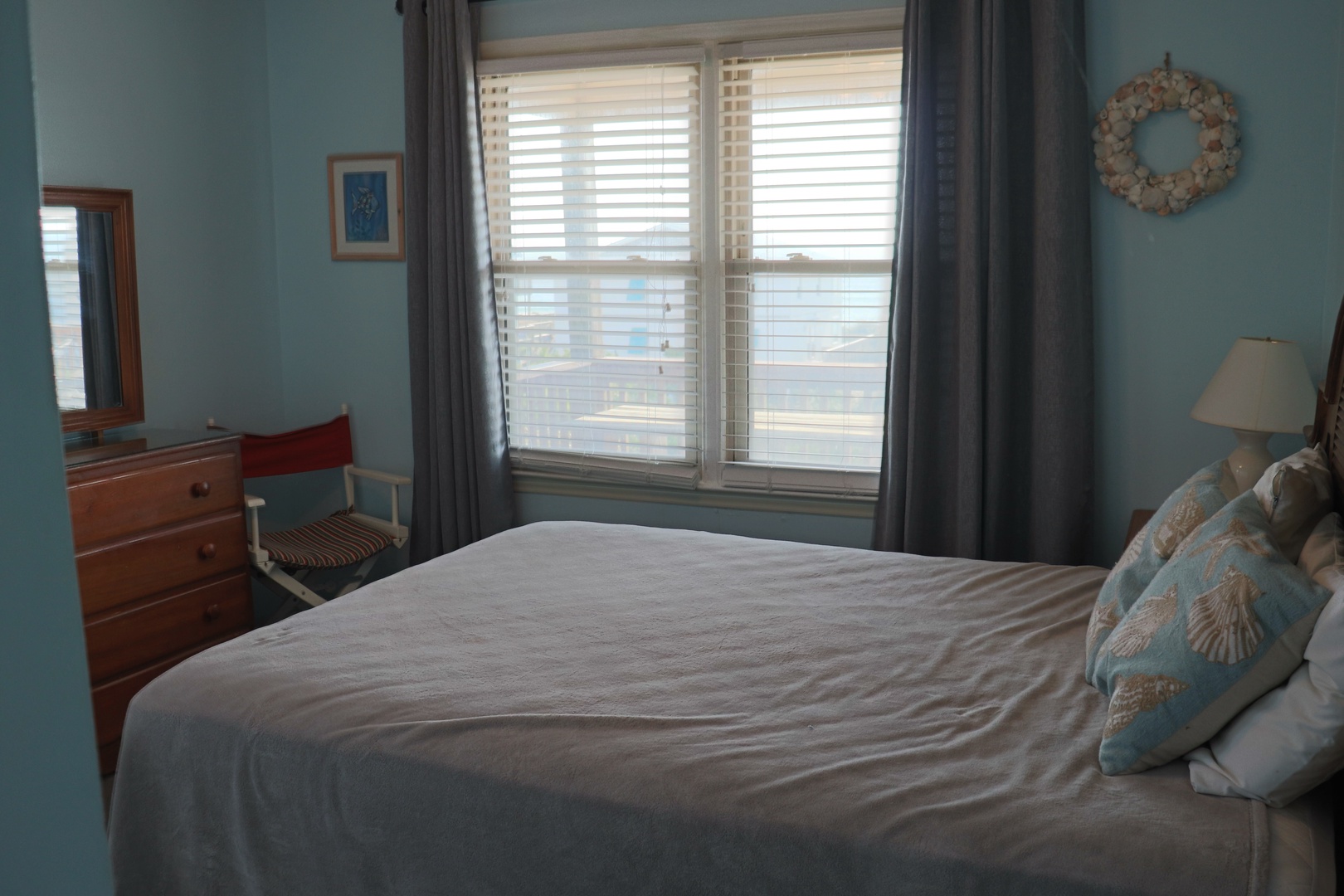 Unwind in your peaceful bedroom with soft coastal tones and natural light streaming through blinds.