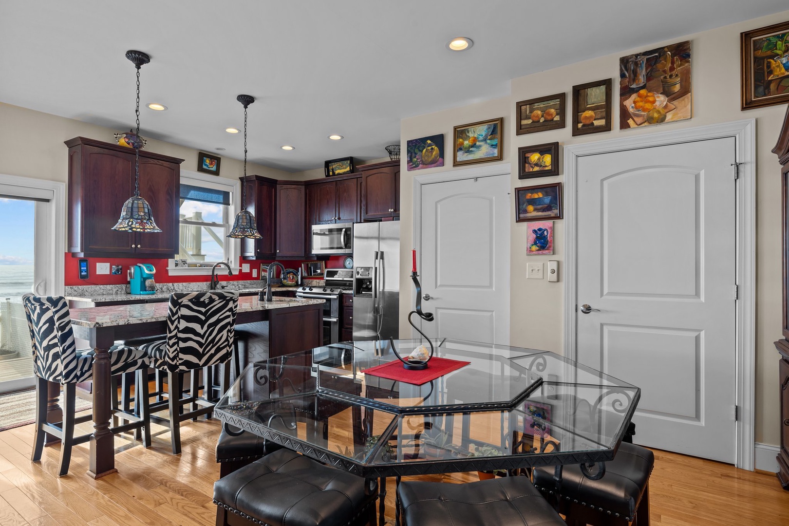 Cook meals in this fully-equipped kitchen featuring dark wood cabinets, granite counters, and a convenient breakfast bar for casual dining.