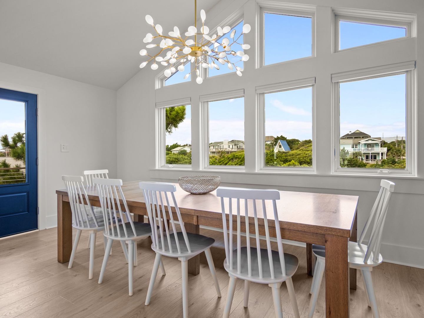 Gather around your beautiful dining table while soaking in panoramic views through floor-to-ceiling windows that fill the space with natural light.