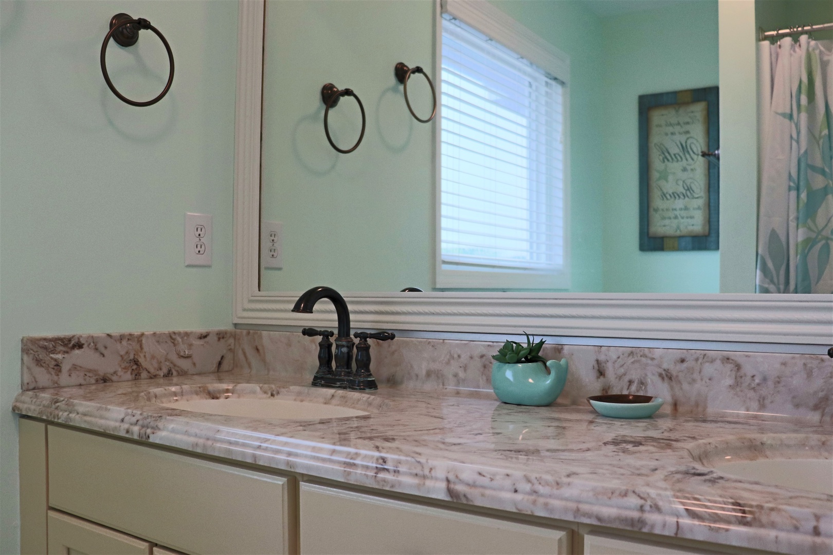 Refresh in your elegant marble bathroom with spa-inspired mint green walls and thoughtful touches that make morning routines feel luxurious.