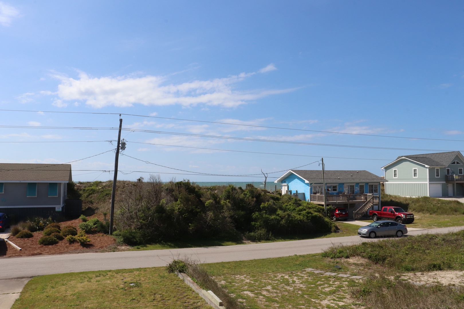 Coastal neighborhood with ocean views and beach houses creates a perfect seaside getaway setting.