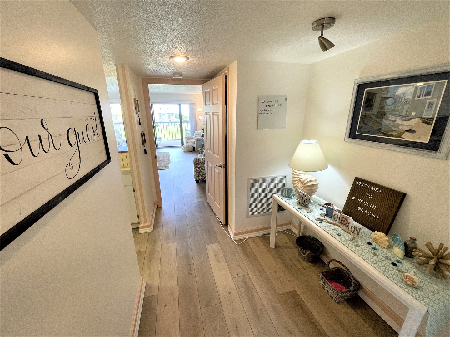 Step into your coastal retreat where warm hardwood floors and thoughtful beach-themed touches create an instantly welcoming atmosphere for your getaway.