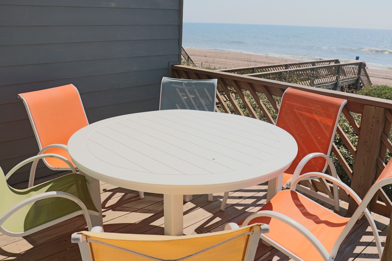 Savor morning coffee or evening meals at your private deck table while watching waves roll onto the sandy shore below.