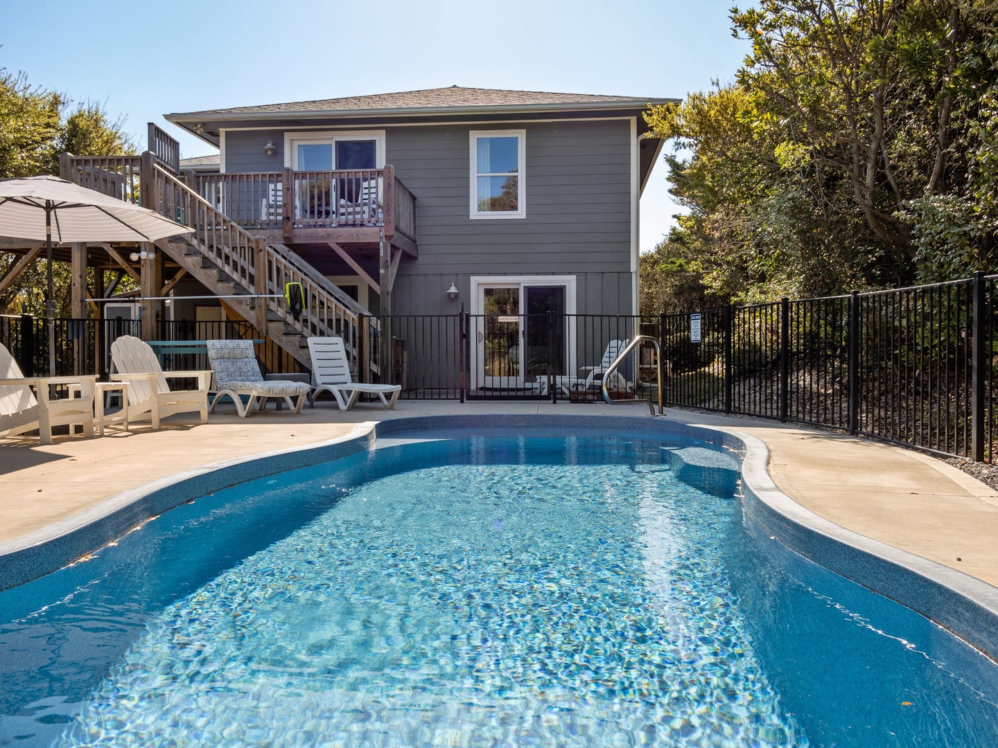 Dive into your private oasis! This sparkling pool awaits your morning swim, surrounded by comfortable lounge chairs for afternoon relaxation.