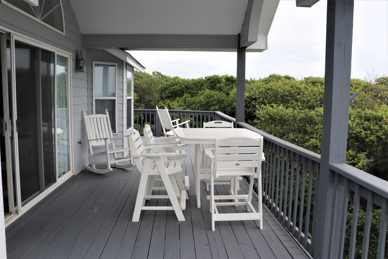 Unwind on your private deck with comfortable seating overlooking lush treetops—perfect for morning coffee or evening relaxation.