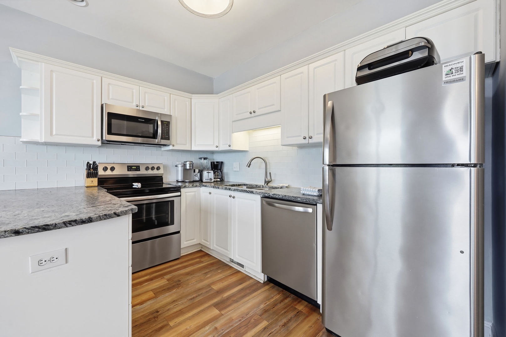 Bright, fully equipped kitchen with stainless appliances and granite countertops, ready for you to cook your favorite meals during your stay.