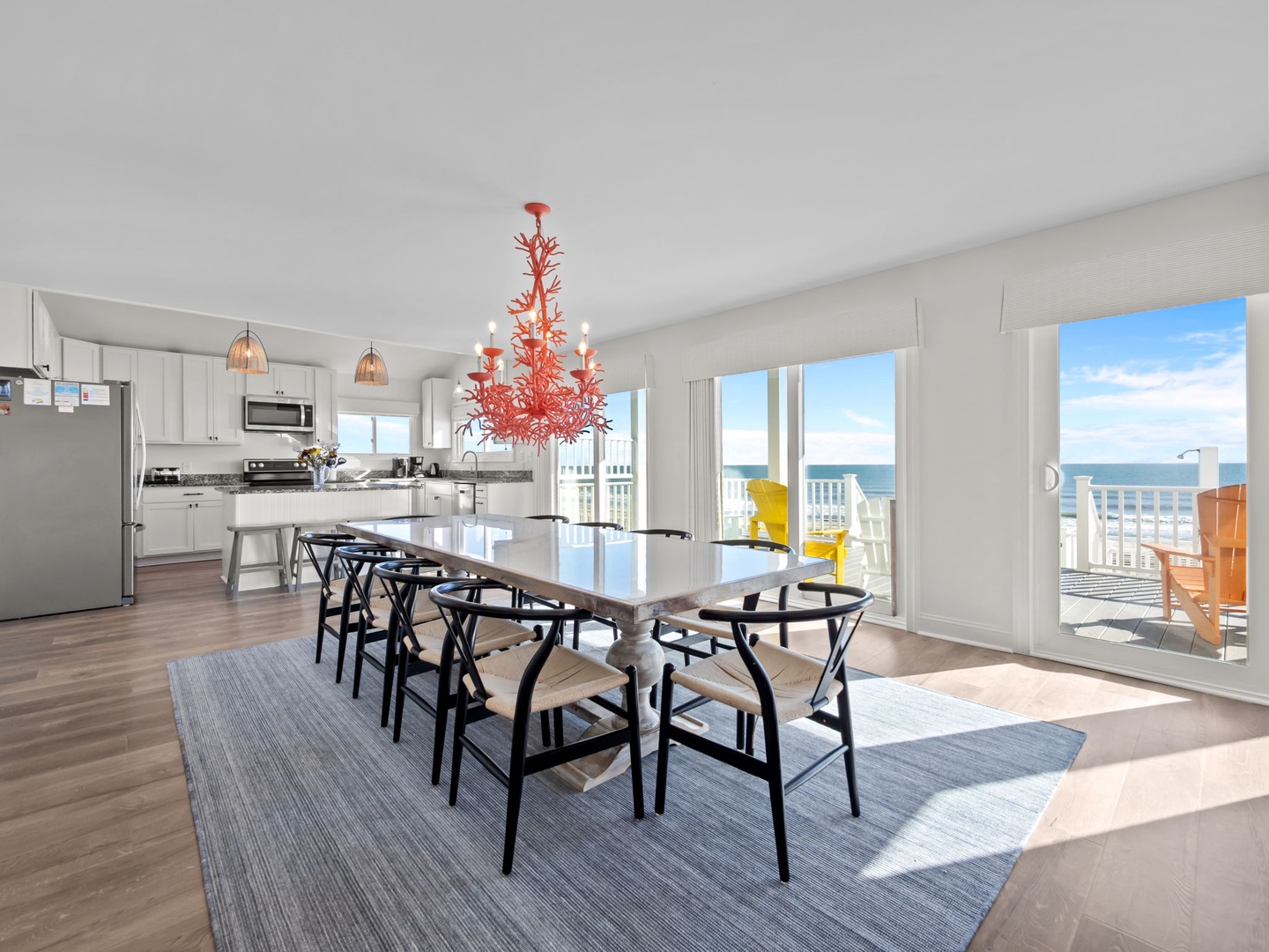 Gather around your stunning dining table where ocean breezes flow through bright windows and coral chandeliers create the perfect atmosphere for memorable meals.