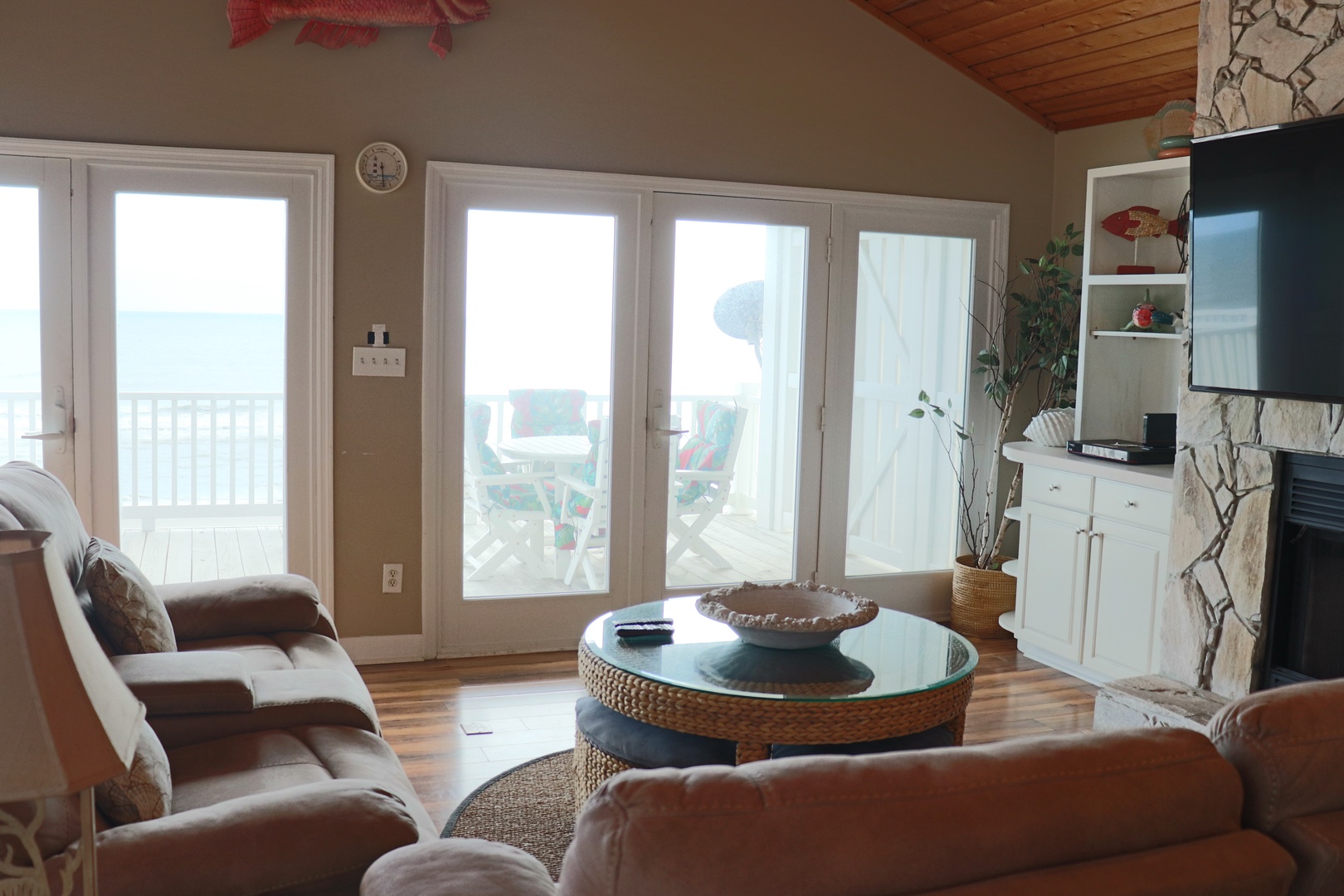 Sink into plush seating while natural light floods your cozy living space, complete with fireplace warmth and peaceful balcony views.