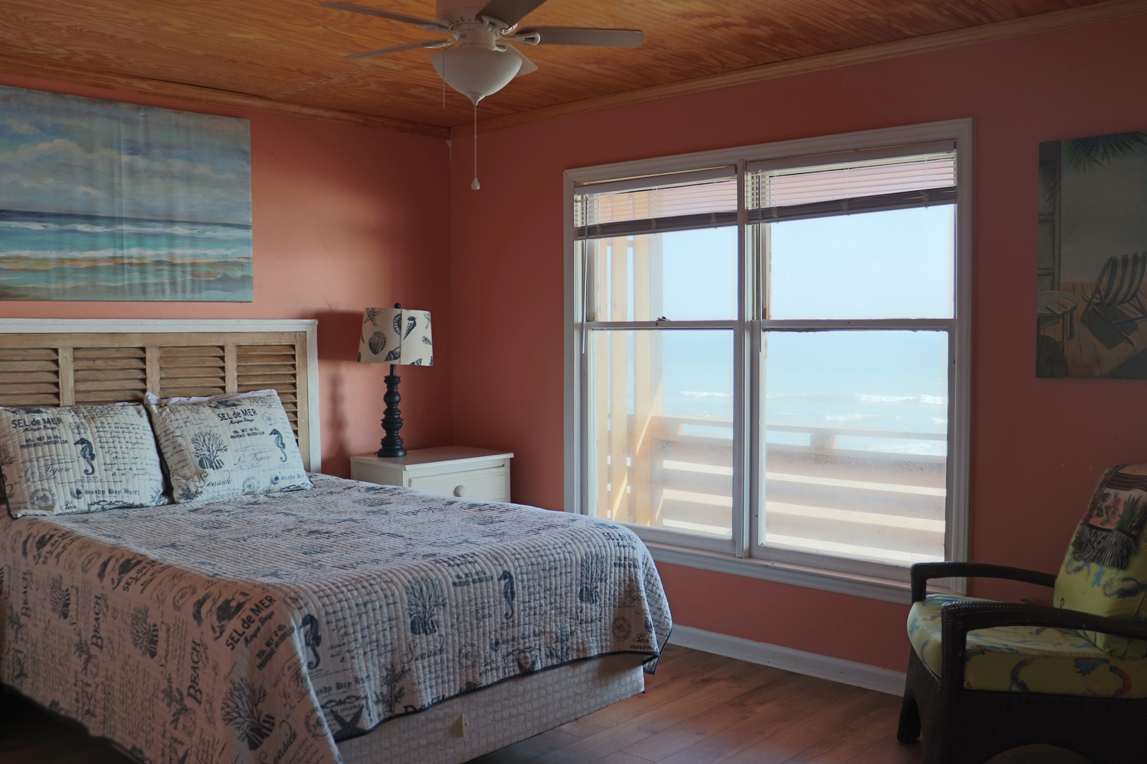 Wake up to breathtaking ocean views from your comfortable bed, where coastal decor and gentle ceiling fan breezes create the perfect seaside retreat.