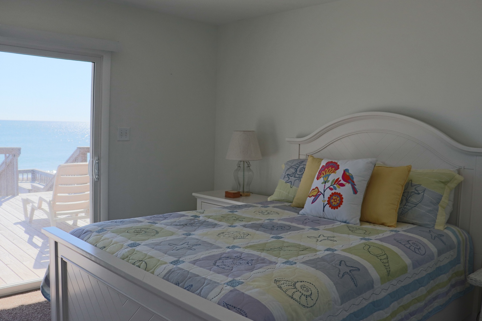 Wake up to stunning ocean views from your comfortable bed, where colorful linens and soft pillows await your peaceful nights.