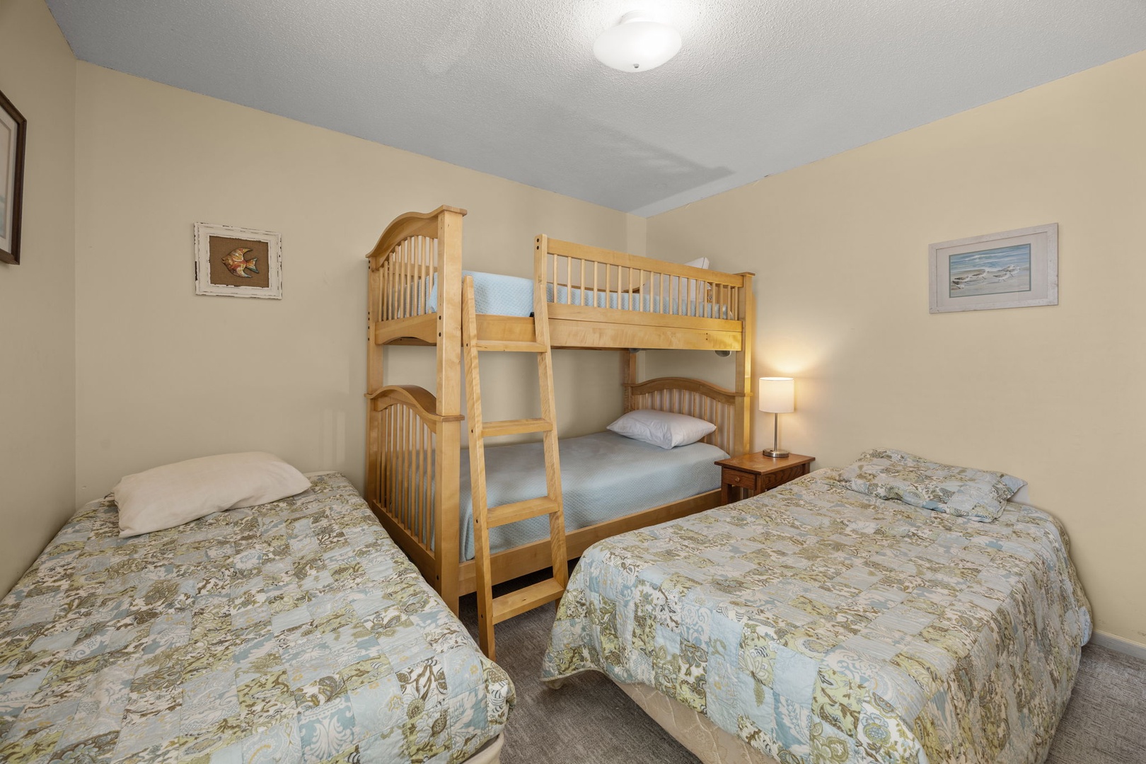 Rest comfortably in your versatile bedroom featuring a cozy bunk bed and two single beds, perfect for families or groups seeking flexible sleeping arrangements.