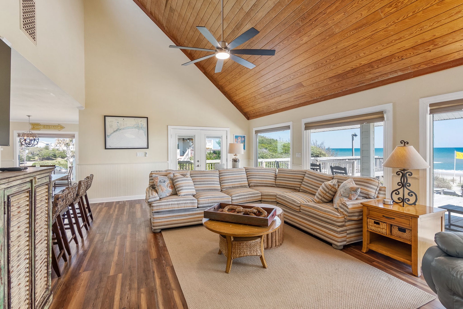 Relax in your bright living room featuring a beautiful wood ceiling and stunning ocean views right outside your windows.