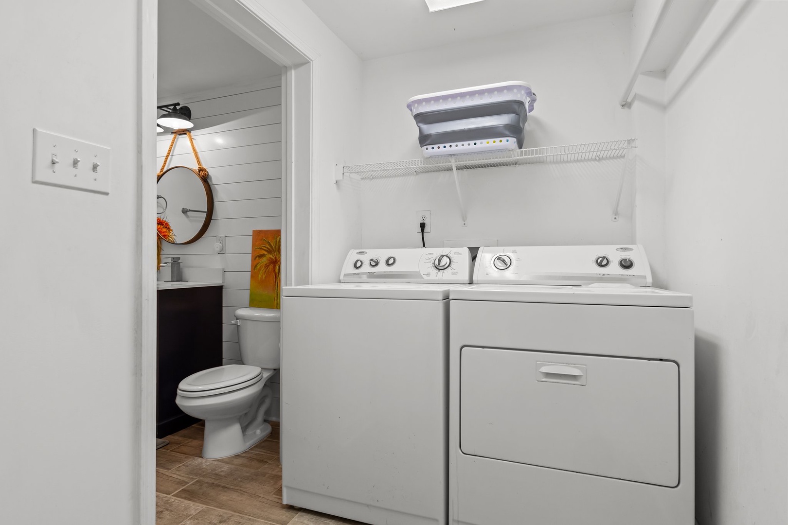 Your dedicated laundry space features full-size washer and dryer with organized shelving for all your fresh linens and supplies.