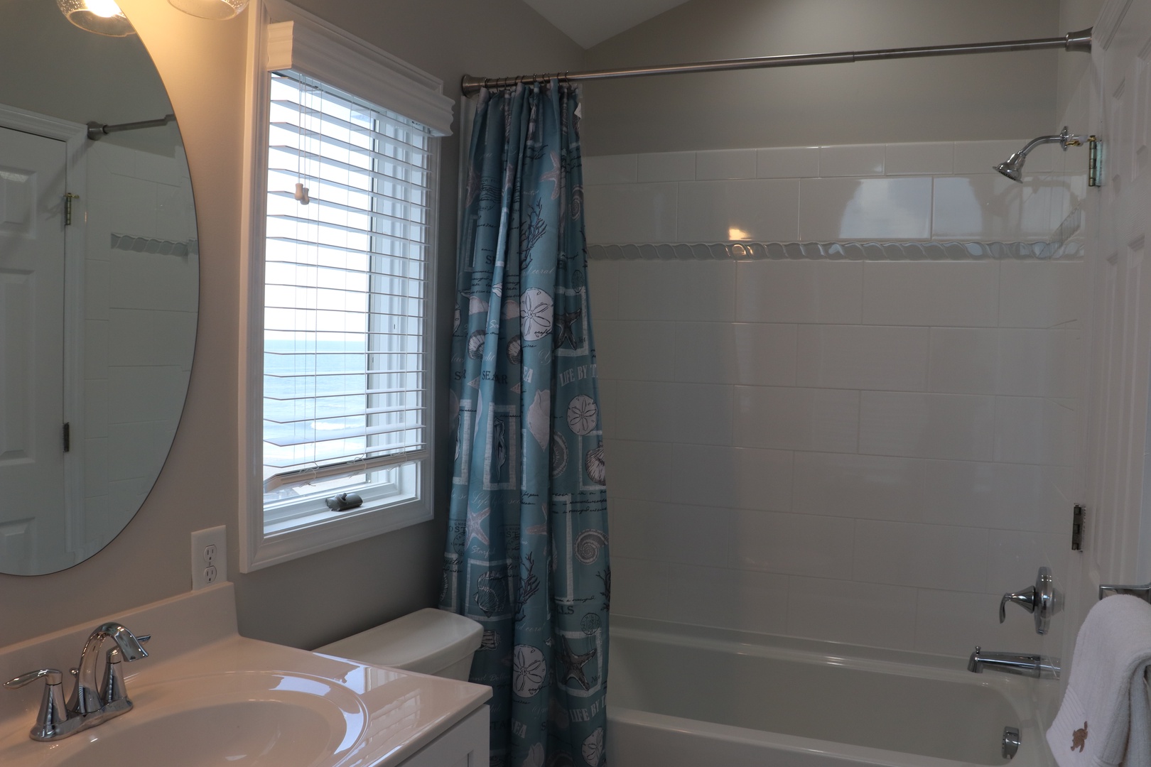 Freshen up in your private bathroom with a relaxing tub-shower combo and coastal-themed touches that make you feel at home.