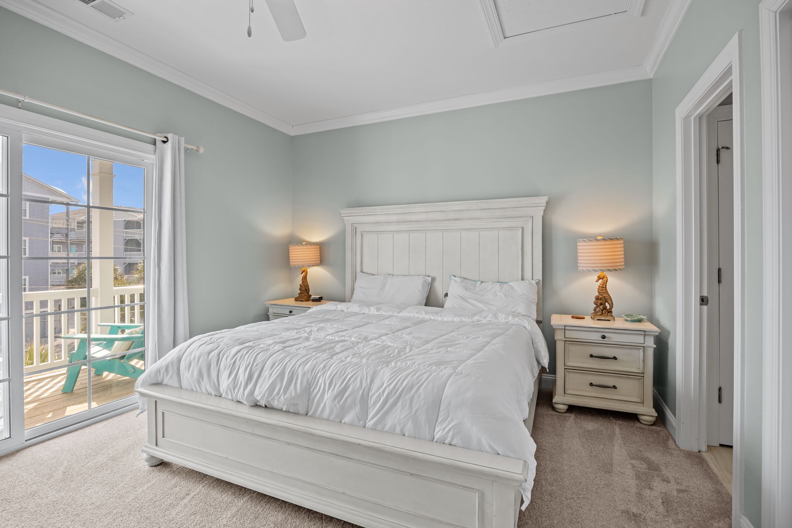 Drift off in your serene coastal bedroom, where soft sage walls and crisp white linens create the perfect retreat.