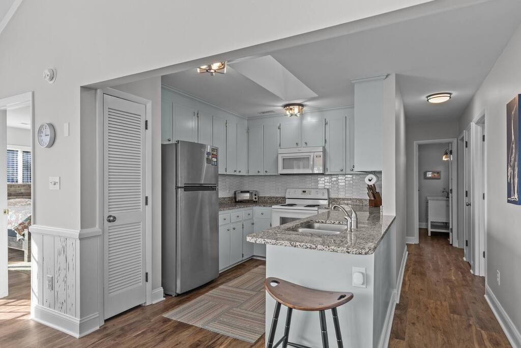 You'll love cooking in this modern kitchen with granite countertops, stainless steel appliances, and convenient breakfast bar seating.