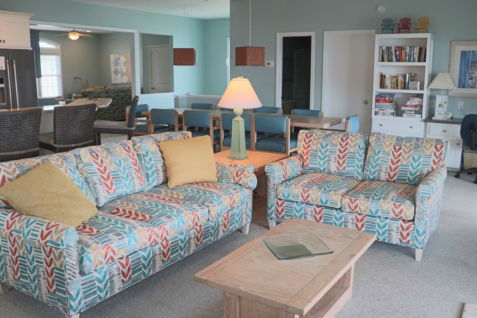 Sink into these cheerful patterned sofas where you can unwind with a book from the built-in shelves, enjoying coastal colors throughout your spacious retreat.