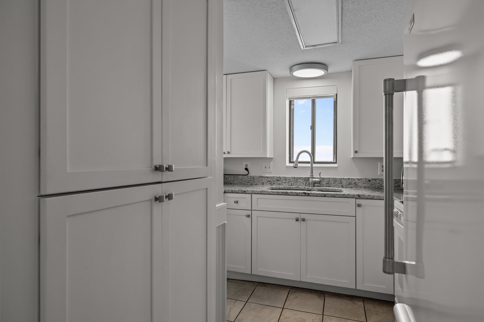 Your bright, fully-equipped kitchen features granite counters and plenty of cabinet space for preparing meals during your stay.