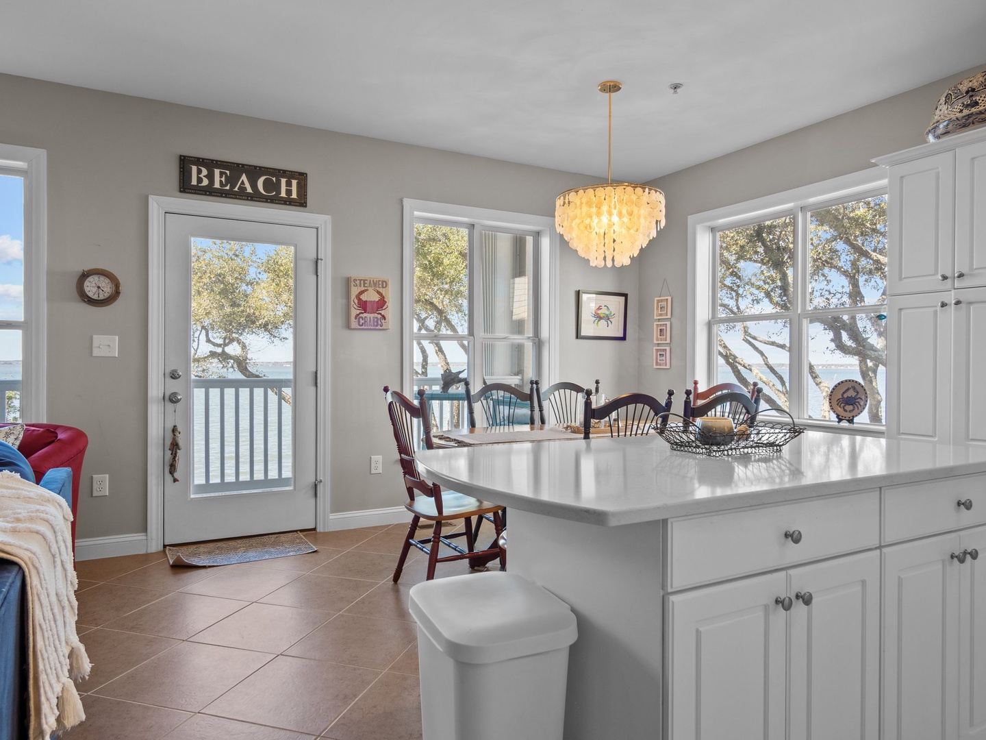 Your coastal kitchen opens to waterfront views through French doors, where morning coffee tastes better with sea breezes.