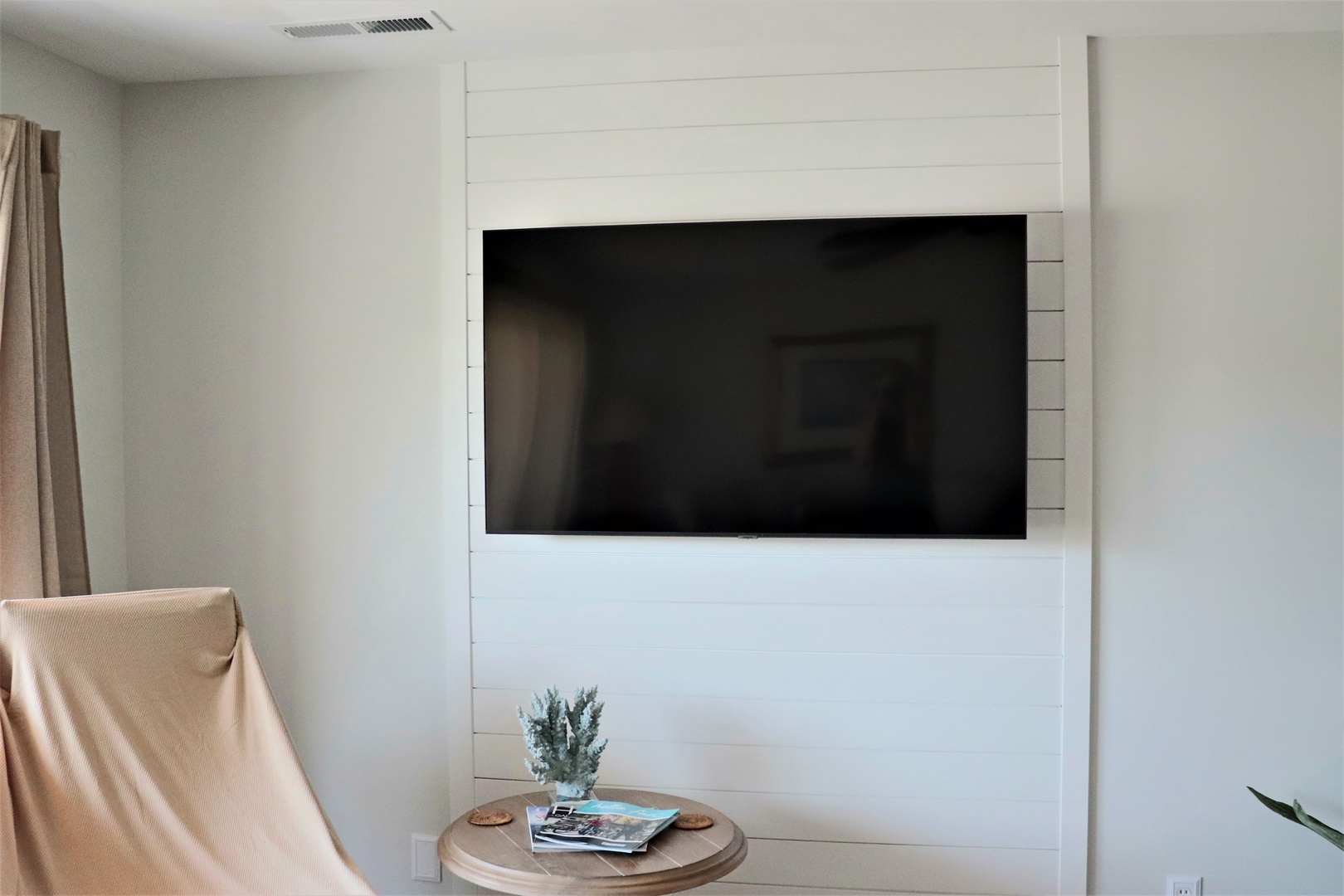 Unwind in your stylish living space with a large flat-screen TV perfectly positioned for cozy movie nights and relaxing evenings.