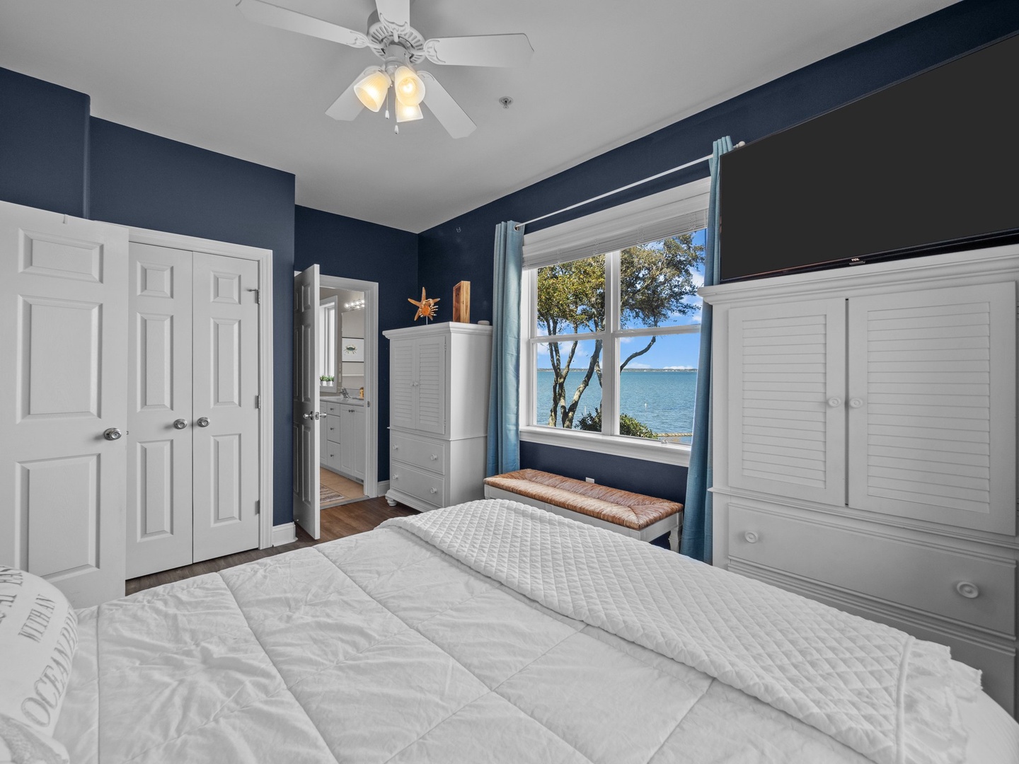 Wake up to stunning water views from your comfortable bedroom, where crisp linens and coastal decor create your perfect lakeside retreat.