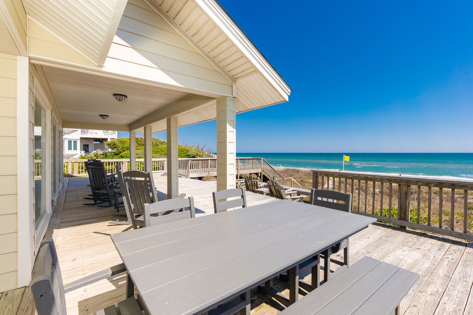 Gather around this spacious oceanfront deck where your morning coffee tastes better with endless sea views and gentle ocean breezes.