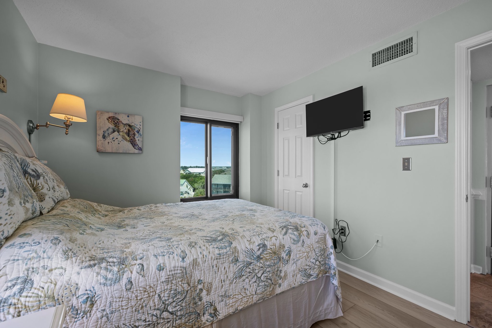 Unwind in your serene bedroom with soft coastal colors and peaceful views through the large window.
