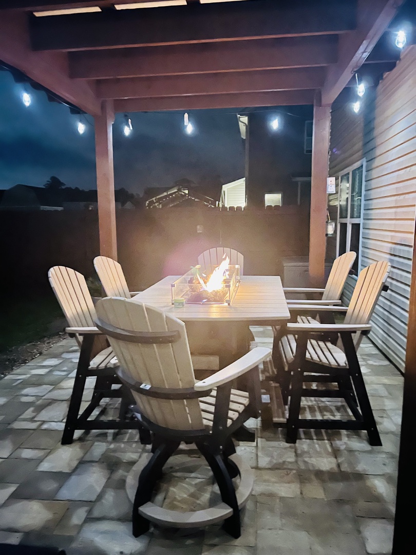Gather around your private fire pit table where cozy evenings unfold under twinkling lights and starlit skies.