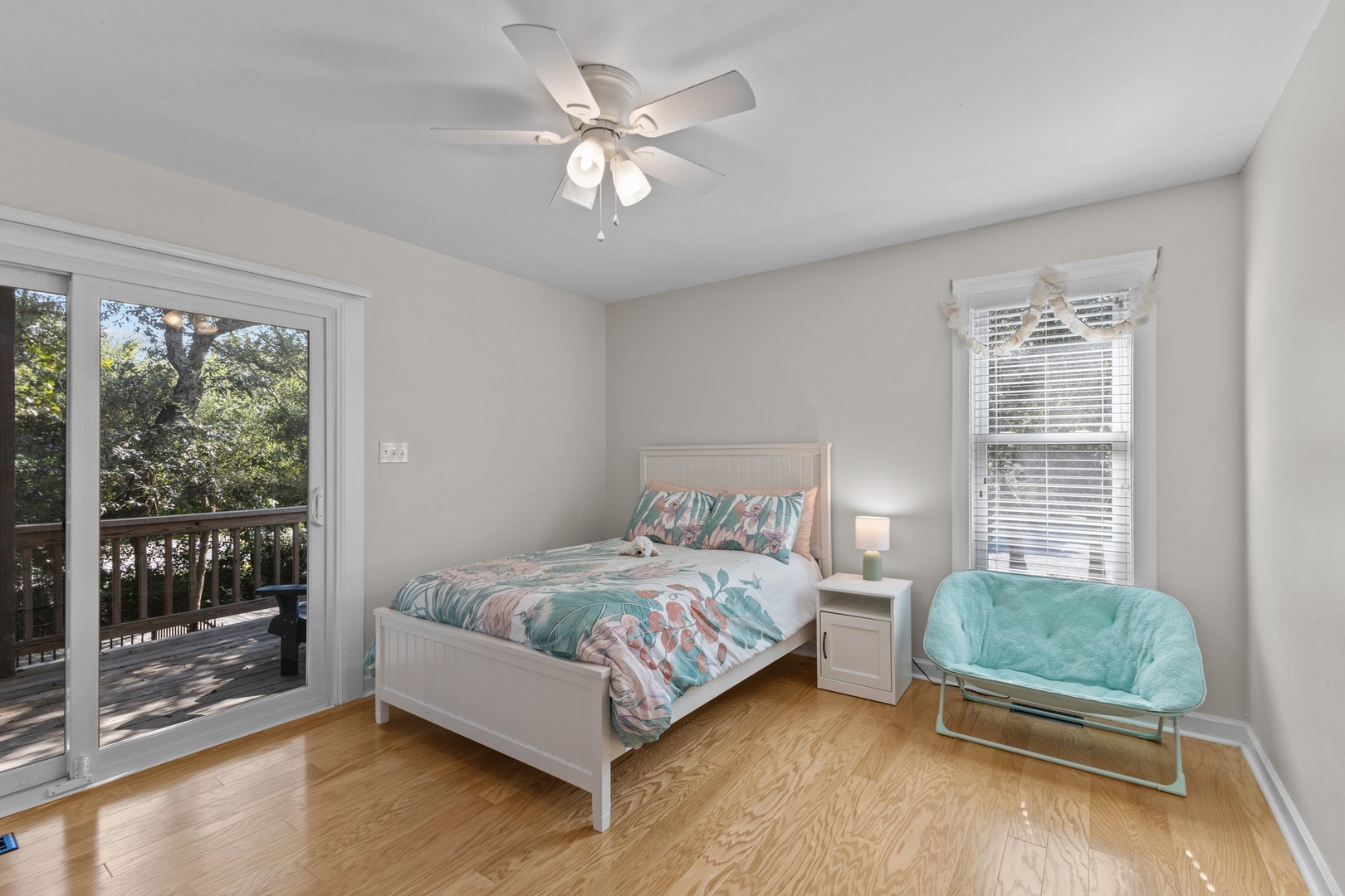 Your peaceful bedroom features natural light, a ceiling fan for comfort, and direct balcony access to enjoy the tree views.