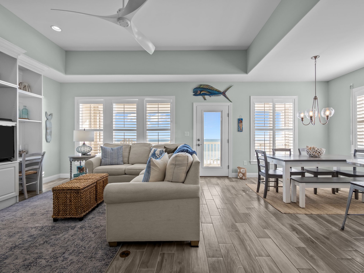 Your coastal-inspired living space features comfortable seating, elegant dining area, and ocean-themed touches that create the perfect beach retreat atmosphere.