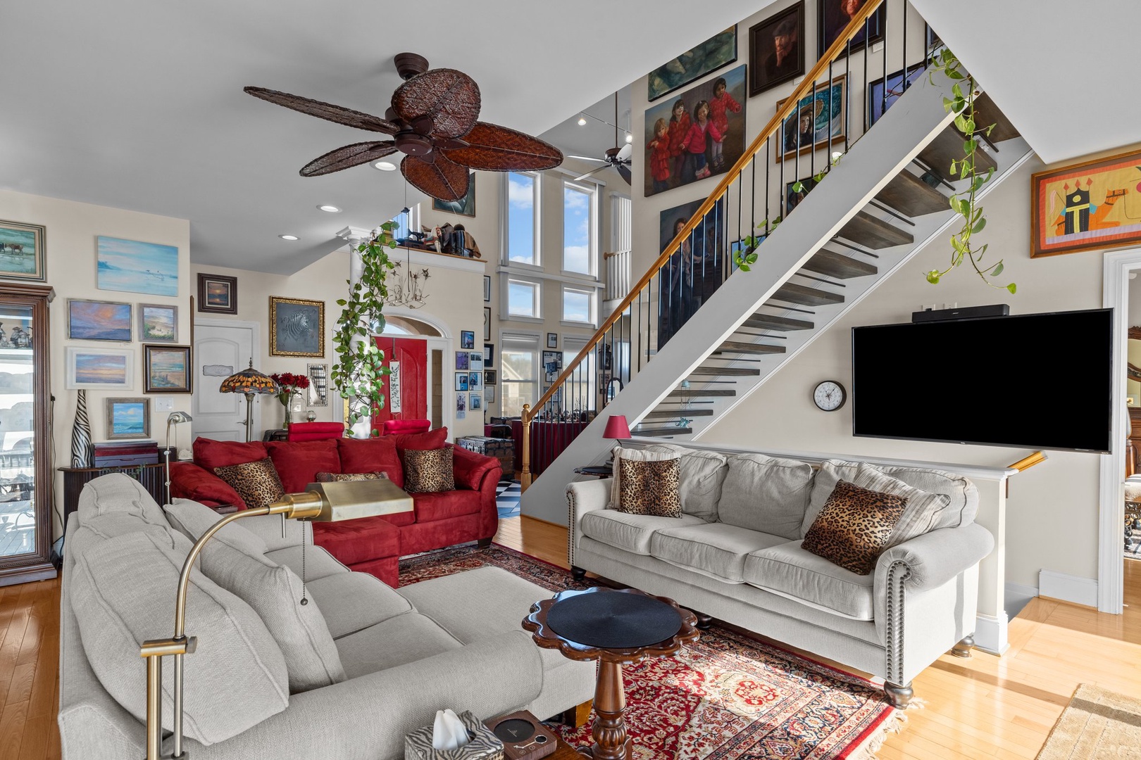 Unwind in this welcoming living room with soaring ceilings, artwork-lined walls, and comfortable seating for your perfect home away from home.
