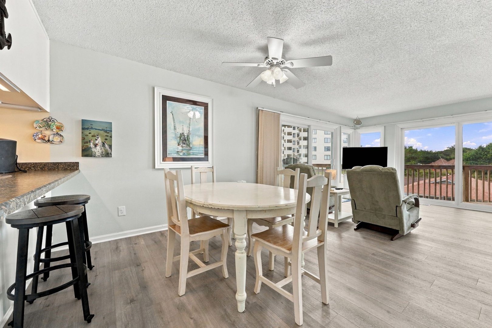 Gather around the dining table and relax in the bright, open living space with comfortable seating and natural light streaming in—perfect for your morning coffee or evening conversations.