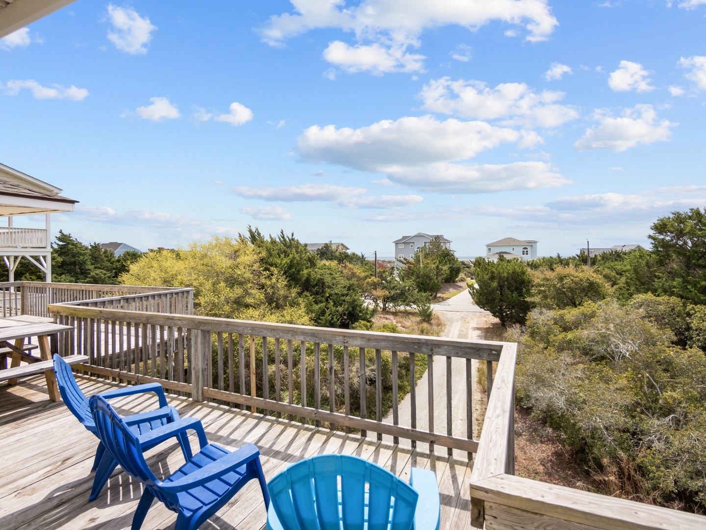 Unwind on your private deck with comfortable seating while taking in peaceful views of the coastal neighborhood and lush greenery.
