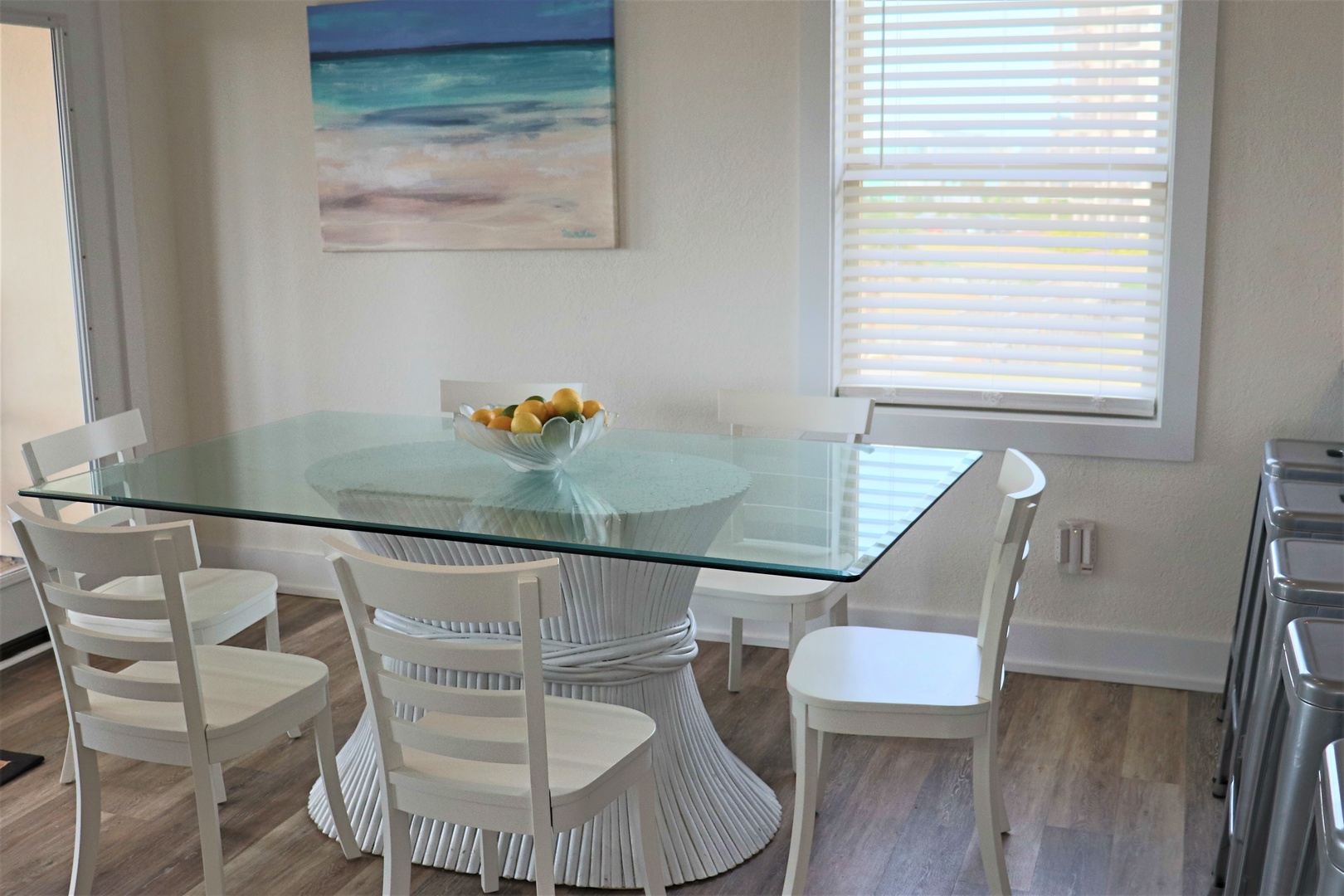 Your bright dining space features a stunning glass table where morning coffee and evening meals become special moments together.