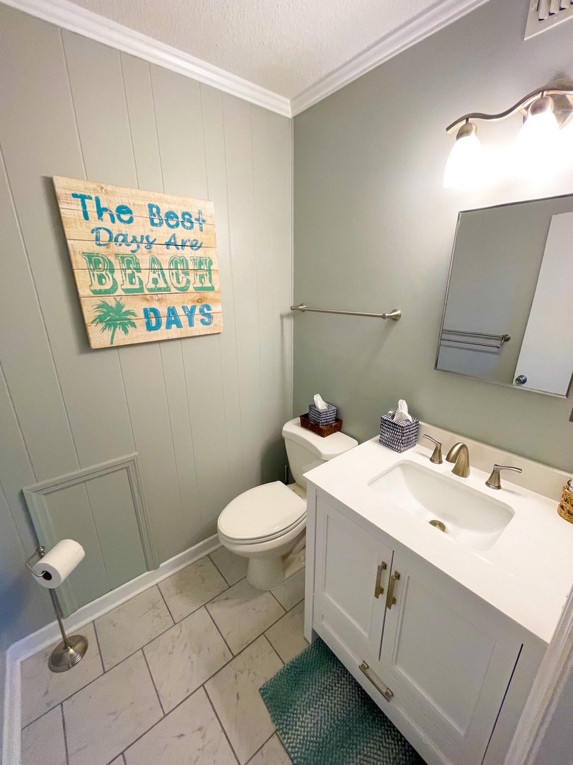 Step into your beach-themed bathroom where coastal charm meets comfort. The cheerful 'Best Days Are Beach Days' sign sets the perfect vacation mood.
