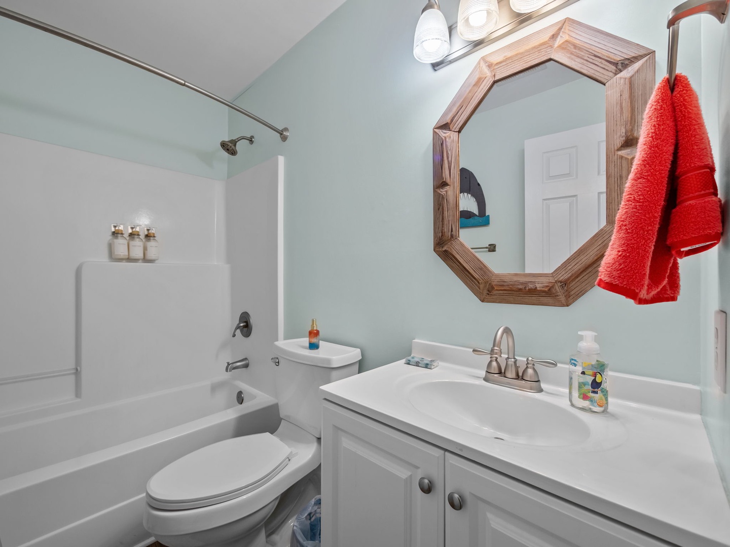 Refresh in your private bathroom with a full tub, shower, and coastal-inspired mint walls that create a spa-like atmosphere.